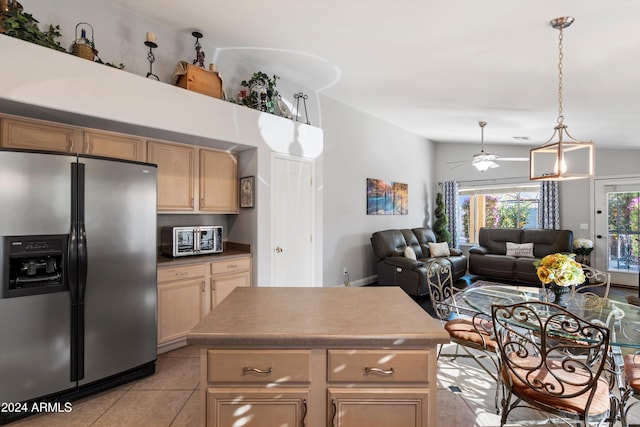 kitchen with ceiling fan, a center island, stainless steel fridge with ice dispenser, lofted ceiling, and light tile patterned flooring