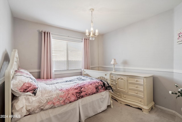 carpeted bedroom with an inviting chandelier