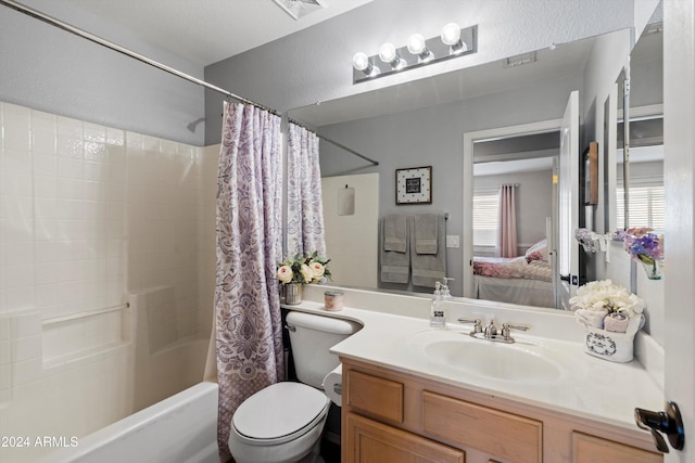 full bathroom featuring vanity, shower / tub combo, and toilet