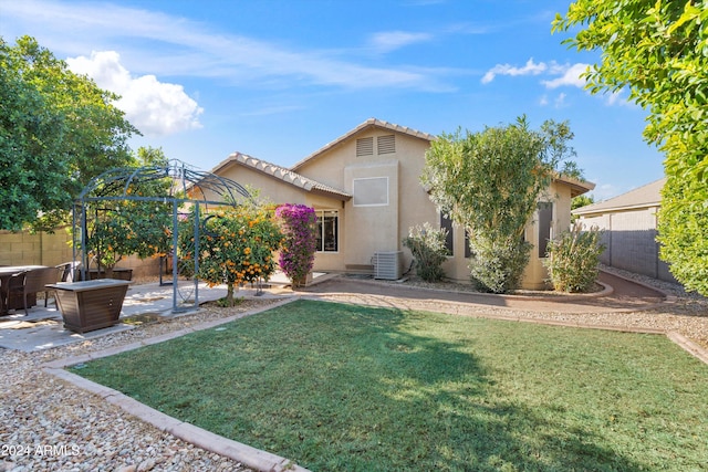 back of property featuring a gazebo, a patio area, a lawn, and cooling unit