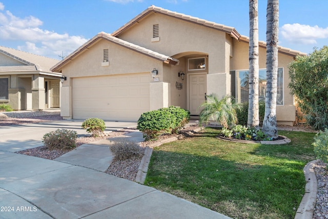 view of front of house featuring a garage and a front lawn