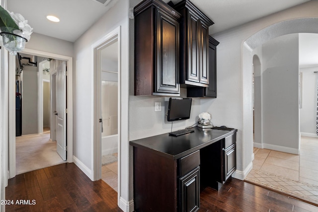 kitchen with dark brown cabinets and dark wood-type flooring