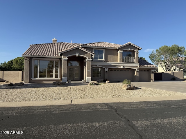 7524 E Leland Cir, Mesa, AZ 85207 - mediterranean / spanish-style home featuring a tiled roof, concrete driveway, a chimney, and stucco siding