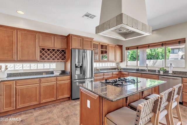 7524 E Leland Cir, Mesa, AZ 85207 - kitchen featuring appliances with stainless steel finishes, brown cabinets, dark stone counters, and recessed lighting