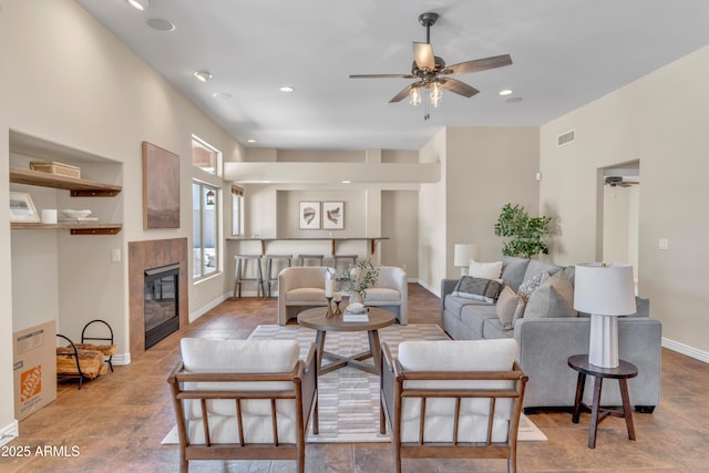 7524 E Leland Cir, Mesa, AZ 85207 - living room featuring ceiling fan, a tiled fireplace, recessed lighting, and baseboards