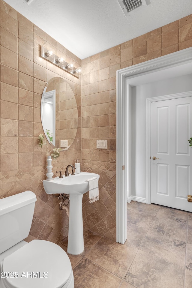 7524 E Leland Cir, Mesa, AZ 85207 - half bathroom with tile walls, toilet, and tile patterned flooring
