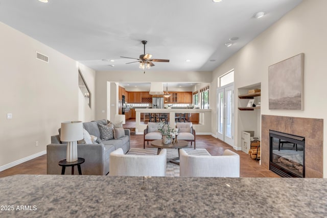 7524 E Leland Cir, Mesa, AZ 85207 - living area featuring ceiling fan, a tile fireplace, baseboards, and recessed lighting