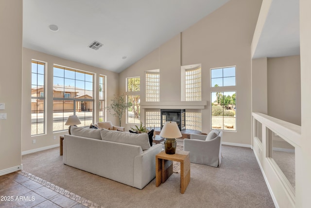 7524 E Leland Cir, Mesa, AZ 85207 - carpeted living area featuring high vaulted ceiling, a glass covered fireplace, and baseboards