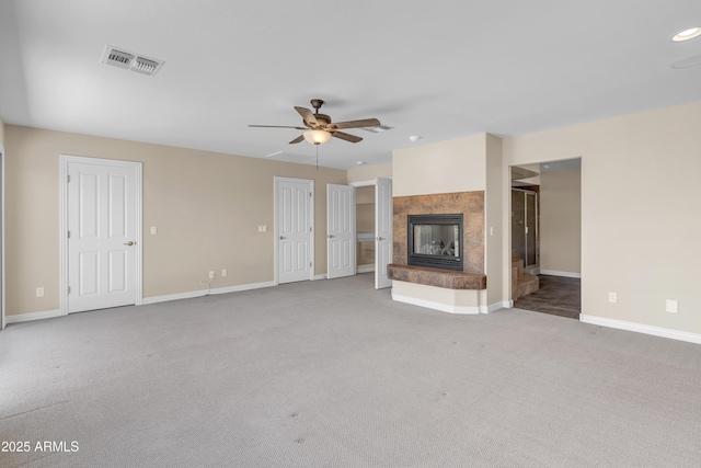 7524 E Leland Cir, Mesa, AZ 85207 - unfurnished living room with carpet floors, a ceiling fan, baseboards, and a fireplace