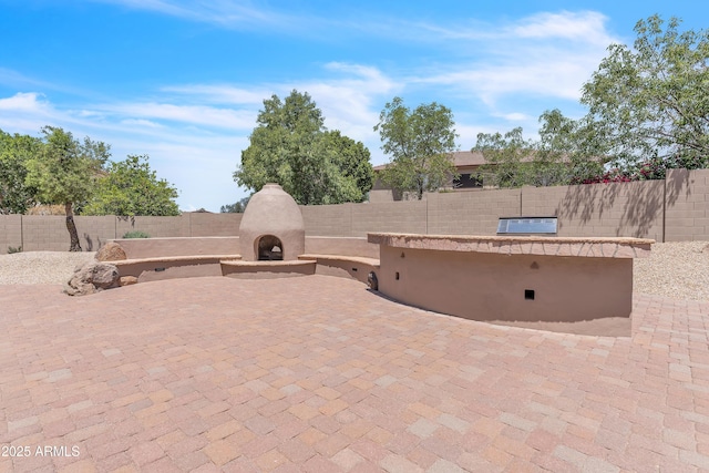7524 E Leland Cir, Mesa, AZ 85207 - view of patio with exterior fireplace and a fenced backyard
