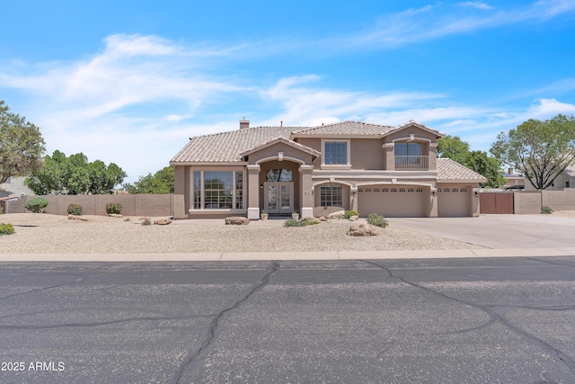 7524 E Leland Cir, Mesa, AZ 85207 - mediterranean / spanish house featuring a tiled roof, stucco siding, fence, concrete driveway, and a garage