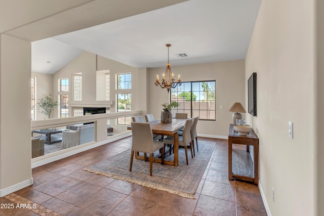7524 E Leland Cir, Mesa, AZ 85207 - dining area featuring baseboards, a chandelier, a fireplace, and vaulted ceiling