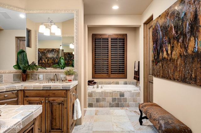 bathroom with a relaxing tiled tub and vanity