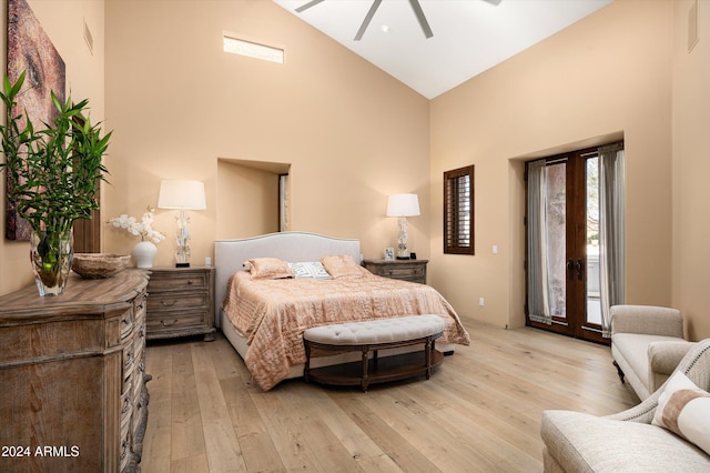 bedroom featuring access to exterior, light hardwood / wood-style floors, high vaulted ceiling, and ceiling fan