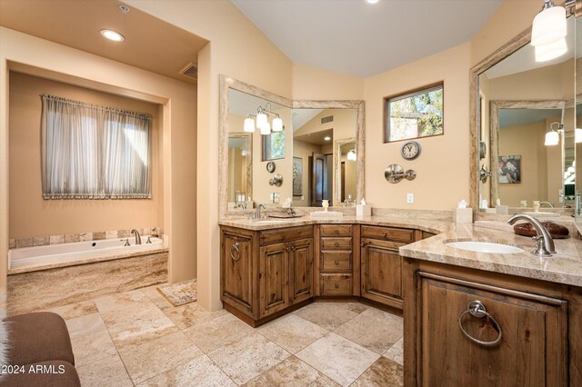 bathroom featuring vanity and a bath