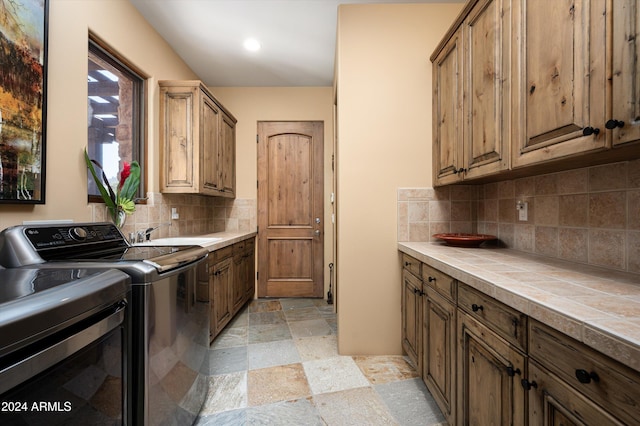 laundry area featuring cabinets, sink, and washer and dryer