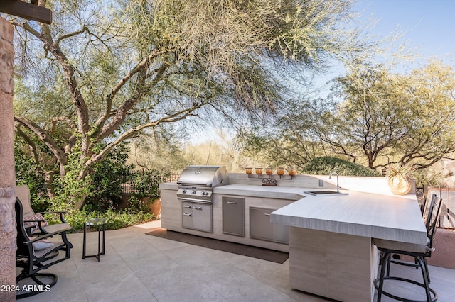 view of patio / terrace with an outdoor kitchen, a grill, and an outdoor wet bar