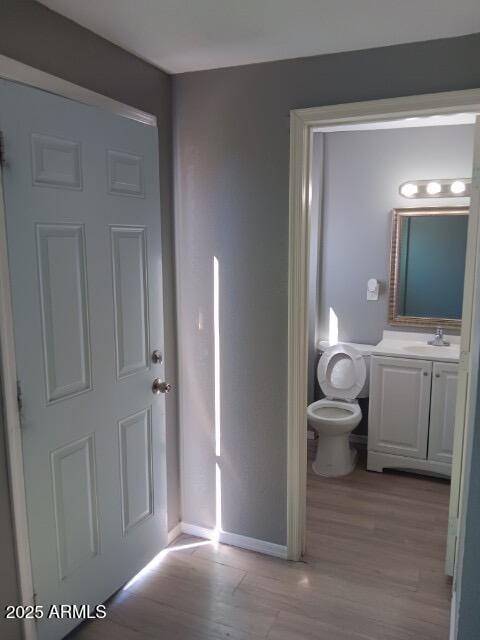 1217 E Hess Ave, Phoenix, AZ 85034 - bathroom with wood finished floors and vanity