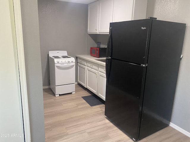 1217 E Hess Ave, Phoenix, AZ 85034 - kitchen featuring black appliances, light wood-type flooring, white cabinets, and light countertops