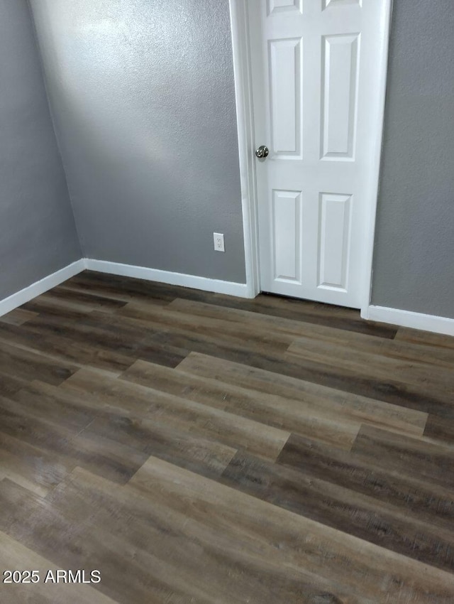 1217 E Hess Ave, Phoenix, AZ 85034 - spare room with baseboards and dark wood-style floors