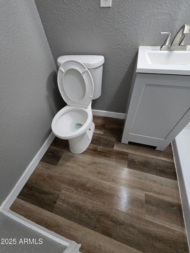 1217 E Hess Ave, Phoenix, AZ 85034 - bathroom with vanity, a textured wall, and wood finished floors