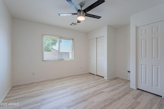 11805 W Sunnyside Dr, El Mirage, AZ 85335 - unfurnished bedroom featuring light wood-type flooring, baseboards, ceiling fan, and a closet