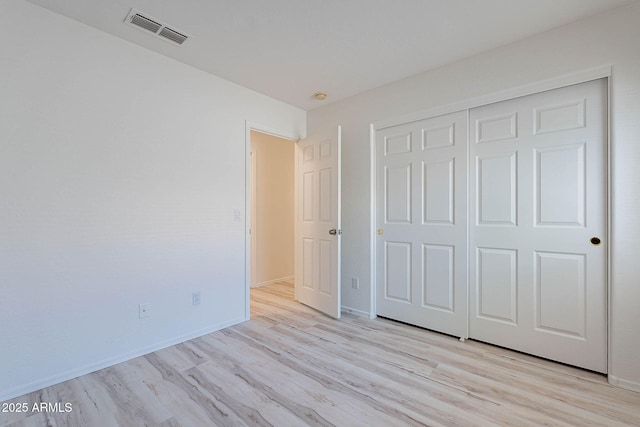 11805 W Sunnyside Dr, El Mirage, AZ 85335 - unfurnished bedroom featuring light wood-style floors, baseboards, and a closet