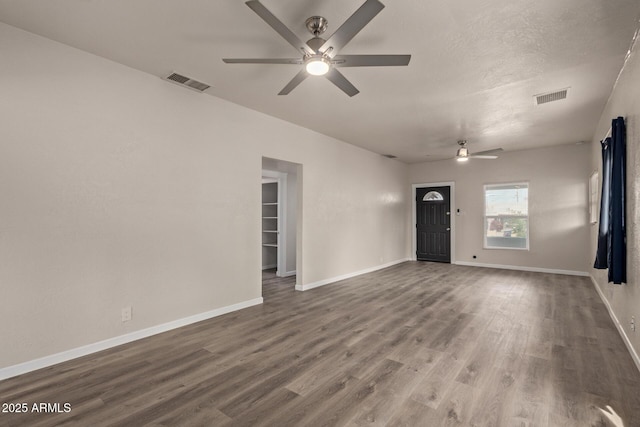 unfurnished living room featuring ceiling fan, hardwood / wood-style floors, and a textured ceiling