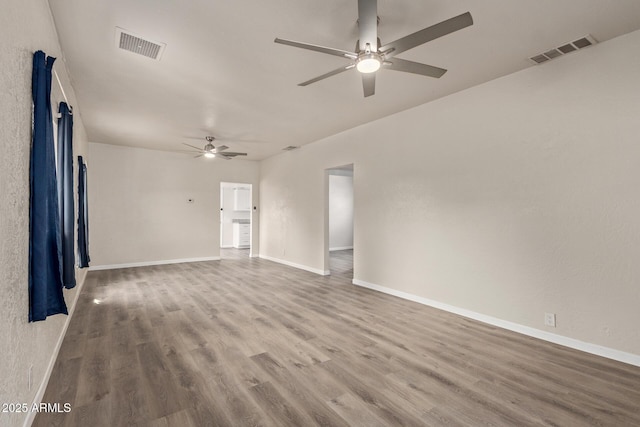 unfurnished room with hardwood / wood-style floors and ceiling fan