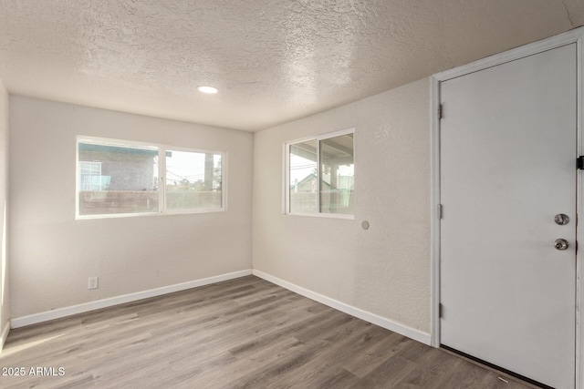 interior space with light hardwood / wood-style floors and a textured ceiling