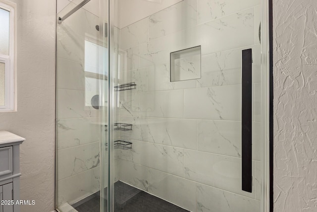 bathroom with vanity and a shower with shower door