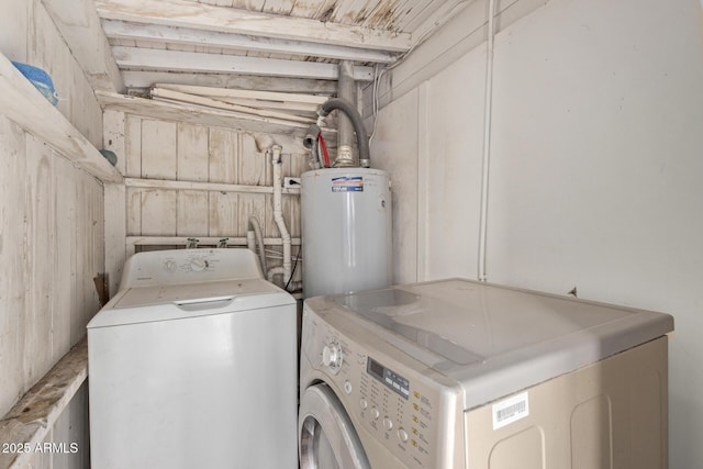 laundry area featuring water heater and washing machine and clothes dryer