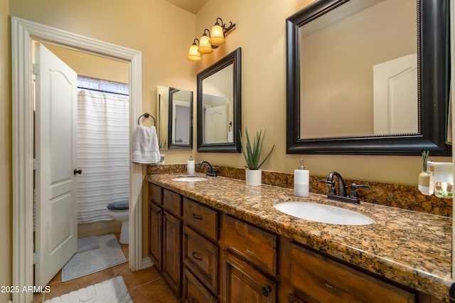 bathroom featuring tile patterned floors, toilet, and vanity