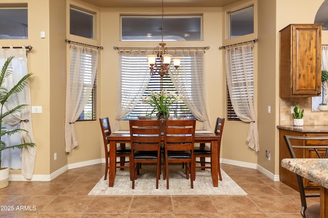 tiled dining area with a notable chandelier