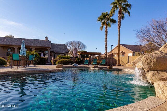 view of swimming pool featuring a patio and pool water feature