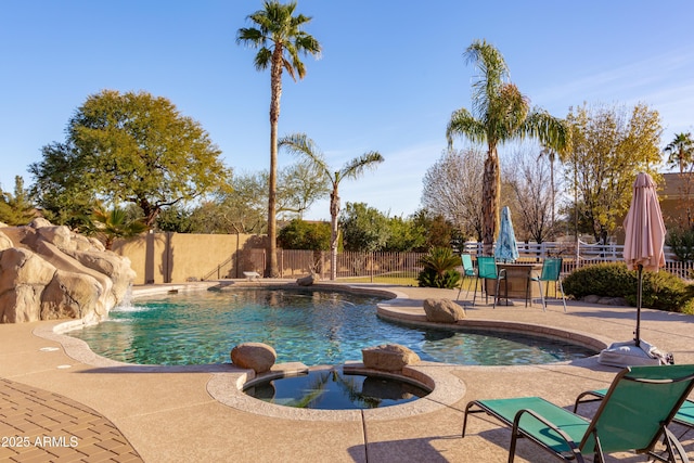 view of pool featuring a patio area and an in ground hot tub