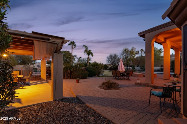 view of patio terrace at dusk