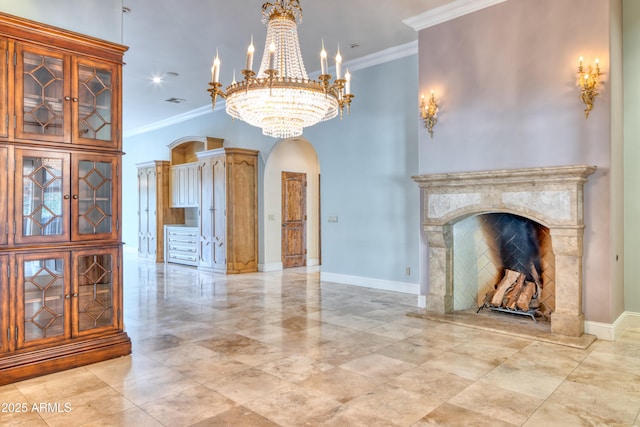 unfurnished living room featuring ornamental molding, a chandelier, and a fireplace