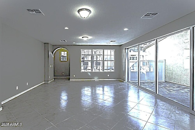 unfurnished room featuring a textured ceiling