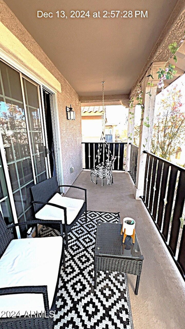 view of patio featuring a balcony