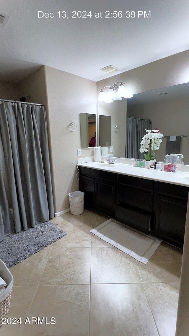 bathroom with tile patterned flooring and vanity