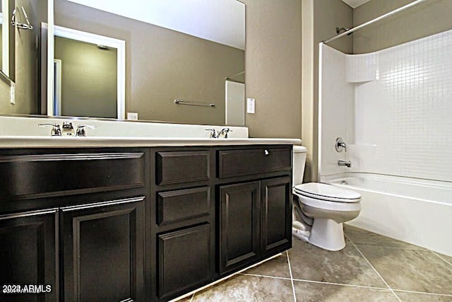 full bathroom featuring toilet, tile patterned flooring, vanity, and washtub / shower combination