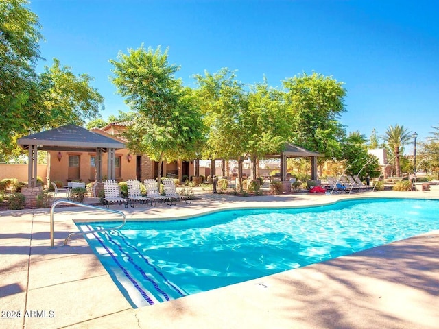 view of swimming pool featuring a gazebo and a patio