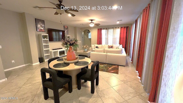 tiled dining area with ceiling fan