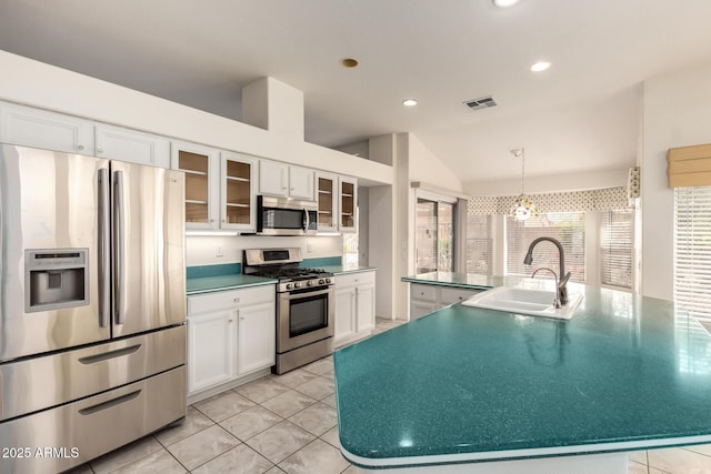 22319 N Desperado Dr, Sun City West, AZ 85375 - kitchen featuring visible vents, white cabinetry, vaulted ceiling, and stainless steel appliances