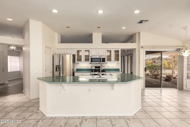 22319 N Desperado Dr, Sun City West, AZ 85375 - kitchen with white cabinets, visible vents, dark countertops, stainless steel appliances, and a center island with sink