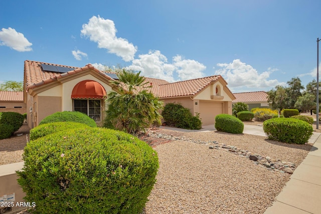 22319 N Desperado Dr, Sun City West, AZ 85375 - mediterranean / spanish house with a tiled roof, stucco siding, solar panels, a garage, and concrete driveway