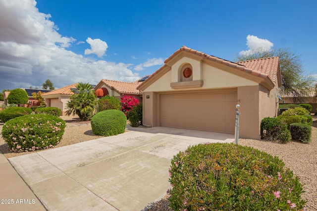 22319 N Desperado Dr, Sun City West, AZ 85375 - mediterranean / spanish-style house featuring a garage, driveway, stucco siding, and a tiled roof