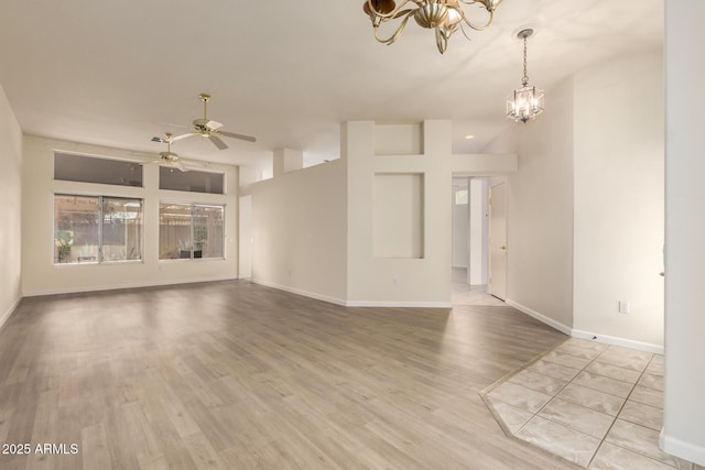 22319 N Desperado Dr, Sun City West, AZ 85375 - empty room with baseboards, ceiling fan with notable chandelier, and wood finished floors