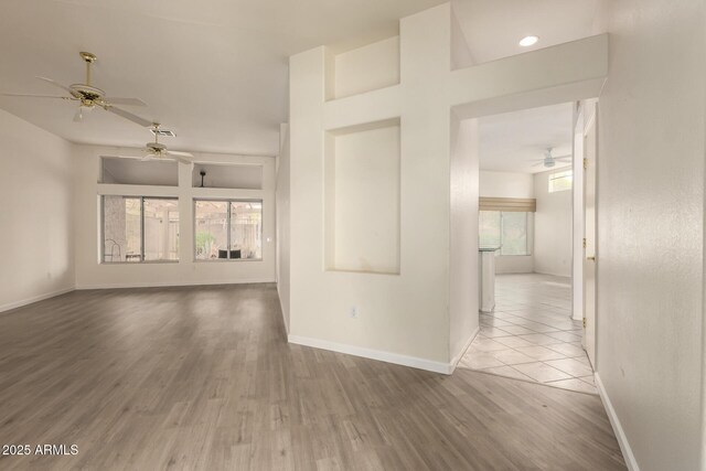 22319 N Desperado Dr, Sun City West, AZ 85375 - unfurnished living room featuring wood finished floors, ceiling fan, and baseboards